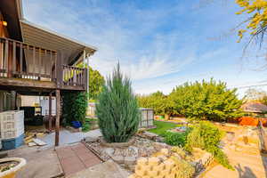 Fenced backyard with a patio and a deck