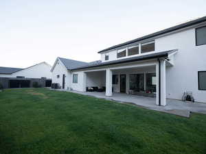 Rear view of house featuring stucco siding and a patio