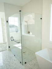 Bathroom with a stall shower and a soaking tub