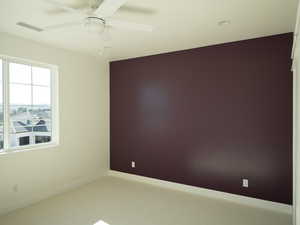 Unfurnished room with a ceiling fan and carpet floors