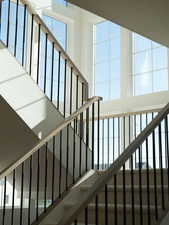 Staircase featuring a towering ceiling