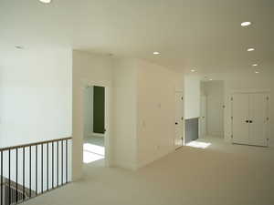 Unfurnished room featuring light carpet and recessed lighting