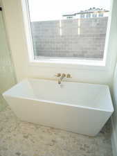 Bathroom featuring a freestanding bath and a sink