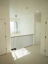 Corridor featuring carpet floors, a chandelier, and recessed lighting