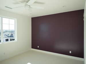 Unfurnished room with carpet and ceiling fan