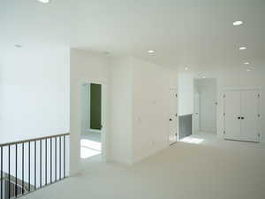 Spare room with light carpet and recessed lighting