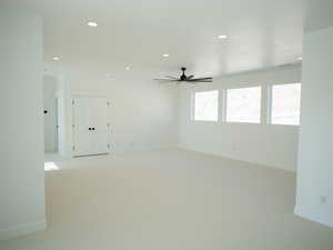 Unfurnished room with recessed lighting, light carpet, and a ceiling fan
