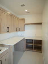 Laundry area with recessed lighting and baseboards