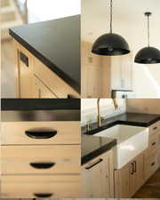 Kitchen with dark countertops, hanging light fixtures, and light brown cabinetry