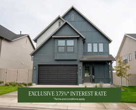 View of front of home featuring board and batten siding, an attached garage, and concrete driveway