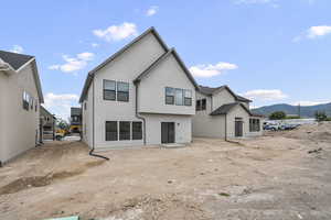 Rear view of house featuring stucco siding