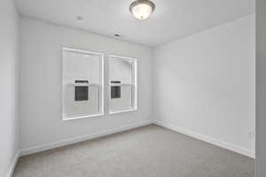 Unfurnished room featuring carpet and baseboards
