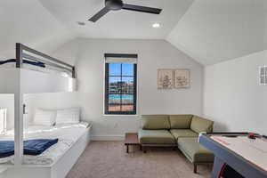 Carpeted bedroom featuring lofted ceiling, a ceiling fan, and recessed lighting