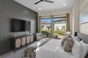 Carpeted bedroom featuring wood walls, a residential view, a ceiling fan, recessed lighting, and access to outside