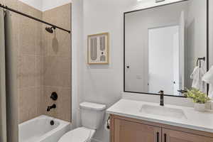 Full bath featuring vanity and shower / bath combo with shower curtain