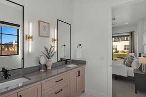 Full bath featuring ensuite bath and double vanity