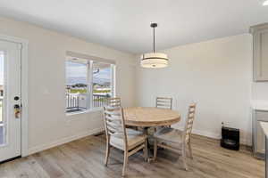 Dining space featuring light wood finished floors and a mountain view