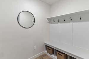 Mudroom featuring baseboards and light wood-style floors