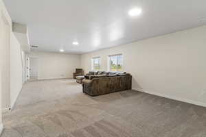 Living room featuring light carpet and recessed lighting