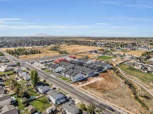 Aerial view of property and surrounding area featuring nearby suburban area