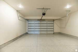 Garage with a garage door opener and recessed lighting