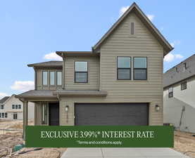 View of front of home featuring a garage and a shingled roof