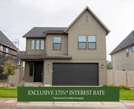 View of front of property featuring a garage and roof with shingles