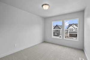 Unfurnished room featuring carpet and a textured ceiling