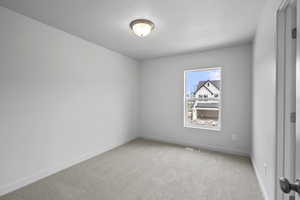 Spare room with carpet and a textured ceiling