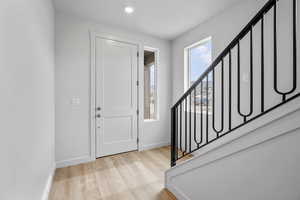 Foyer entrance featuring light wood-style flooring and stairway
