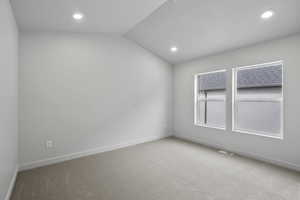 Unfurnished room with carpet flooring, lofted ceiling, and recessed lighting