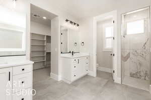 Full bathroom with a marble finish shower, vanity, and recessed lighting