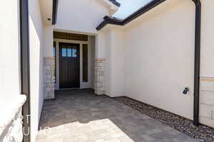 Property entrance with stucco siding and stone siding