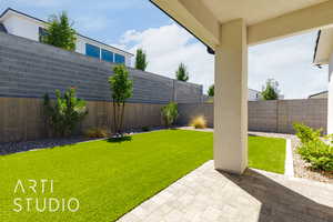 Fenced backyard with a patio