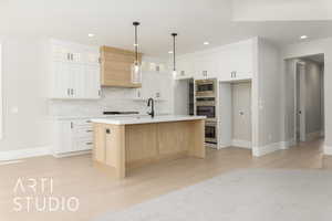 Kitchen with light countertops, recessed lighting, light wood-style flooring, glass insert cabinets, and white cabinetry