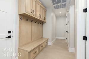 Mudroom featuring light wood-style flooring and recessed lighting