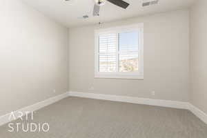 Spare room featuring carpet floors and a ceiling fan