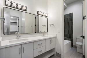 Bathroom featuring double vanity and toilet