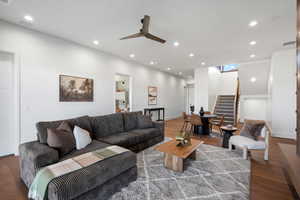 Living area featuring wood finished floors, stairway, recessed lighting, and ceiling fan
