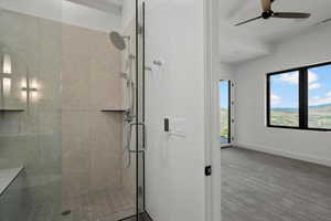 Full bathroom with a stall shower and a ceiling fan