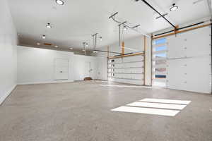 Garage featuring recessed lighting and baseboards