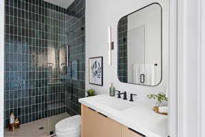 Full bathroom featuring vanity and a tile shower