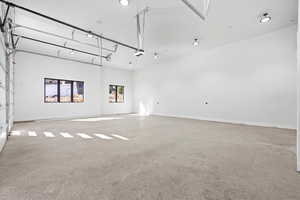 Garage with baseboards and recessed lighting
