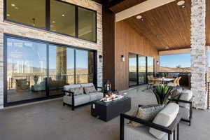 View of patio featuring an outdoor living space with a fire pit
