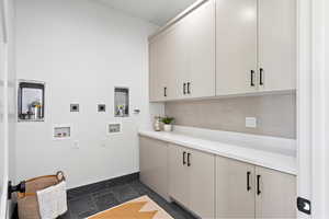 Laundry area with cabinet space, hookup for an electric dryer, and washer hookup