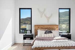 Bedroom featuring wood finished floors and a mountain view
