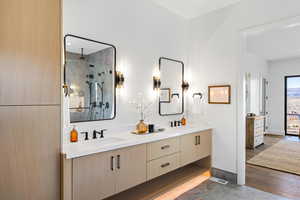 Full bath with double vanity, a shower with shower door, dark tile patterned flooring, and recessed lighting