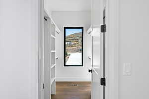 Hall featuring light wood-style flooring and baseboards