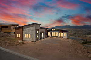 Modern home featuring stone siding