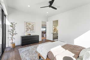 Bedroom featuring recessed lighting, hardwood / wood-style flooring, ensuite bath, and a ceiling fan